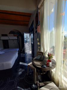 a bedroom with a bed and a laptop on a table at finca casita el mirador in Medellín
