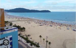 a beach with a large crowd of people at Solar Camorim in Angra dos Reis