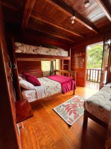 a bedroom with two bunk beds in a cabin at Mindo Green House in Mindo