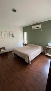 a bedroom with a large bed in a room at Casa cabaña in Paysandú