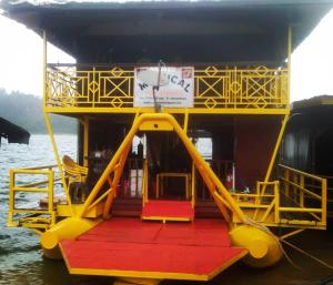 a yellow and red boat in the water at Royal Belum Mystical in Gerik