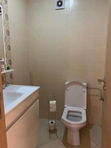 uma casa de banho com um WC branco e um lavatório. em Private and cosy room in a shared apartment em Agadir