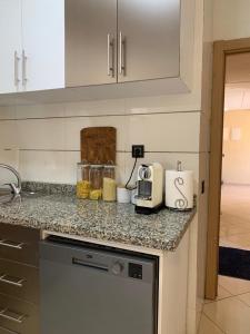 a kitchen with a counter top with a toaster at Private and cosy room in a shared apartment in Agadir