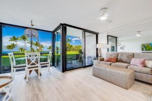 a living room with a couch and a table at KIHEI SURFSIDE #110 condo in Wailea