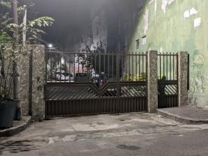 an iron gate in a street with a building at Perto do Pelourinho Quarto Arejado in Salvador +1 photo