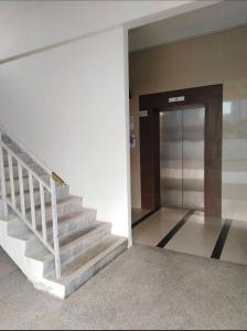a staircase leading to a door in a building at S PICE Arena Homestay in Bayan Lepas