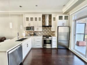 a kitchen with white cabinets and stainless steel appliances at Spacious Home in Richmond in Richmond