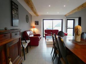 a living room with a table and chairs and a couch at Gîtes contemporains et rénovés avec jardin, terrasse et parking à Moutiers en Beauce - FR-1-581-125 in Moutiers
