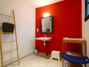 a bathroom with a sink and a red wall at Gîte Moutiers, 9 pièces, 15 personnes - FR-1-581-125 