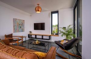a living room with a couch and a tv at Luxury villa with a swimming pool Palit, Rab - 22153 in Rab