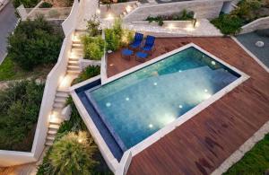 an overhead view of a swimming pool in a backyard at Luxury villa with a swimming pool Palit, Rab - 22153 in Rab