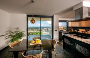 a kitchen with a table with a bowl of fruit on it at Luxury villa with a swimming pool Palit, Rab - 22153 in Rab