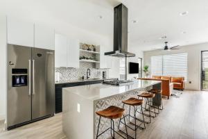 a kitchen with a large island with stools at 25% OFF Weekly New Cozy 4B EVcharger Gym The Haus in Austin