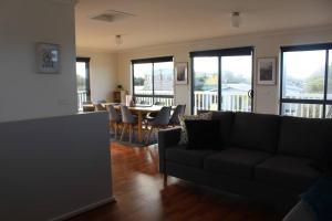 a living room with a couch and a table with chairs at Beach Hideaway in Sunset Strip