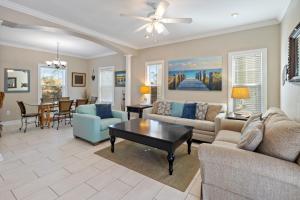 a living room with a couch and a table at Beachcomber Bliss 38C By Pkrm in Pensacola