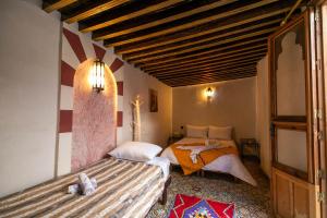 Postel nebo postele na pokoji v ubytování RIAD DAR DIWAN