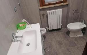 a bathroom with a white sink and a toilet at Lovely Apartment In Luco Dei Marsi With Kitchen in Luco neʼ Marsi