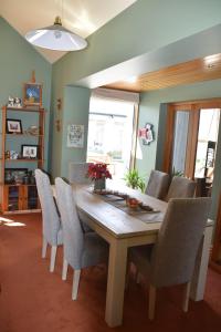 a dining room with a wooden table and chairs at Number 74 on Lockhart in Oturehua