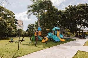 a playground in a park with a slide at Lujoso apartamento Panama in ArraijÃ¡n