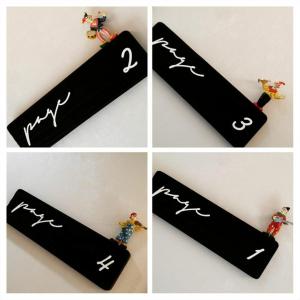 a group of four pictures with handwriting on a tag at Bookmark Guesthouse in Seogwipo