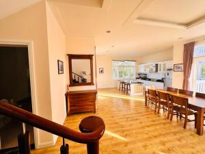 a kitchen and dining room with a table and chairs at Bougainvillea Sealinks City PC16-17-18 in Ấp Phú Tịnh (2)