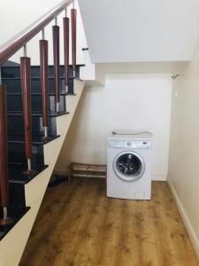 a washing machine in a laundry room under a staircase at Bougainvillea Sealinks City PC16-17-18 in Ấp Phú Tịnh (2)