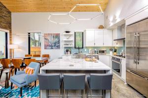 a kitchen with a large island with blue chairs at Stars Over Austin in Austin