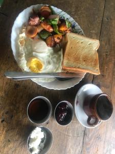 a plate of food with eggs and toast on a table at Sunrise Point Homestay in Nagarkot