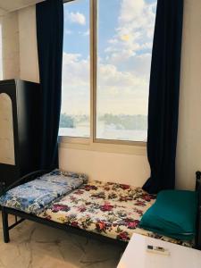 a bed in a room with a window at Single room with window near metro in Dubai