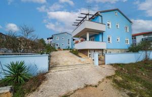 a house with a windmill on the side of it at Beautiful Apartment In Barbariga in Barbariga +10 photos