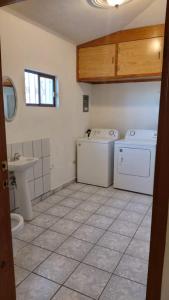 a bathroom with a washing machine and a sink at 6ta Sección #84 in San Carlos