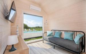 a room with a bed and a tv and a pool at Nice Home In Bobolin With Wi-fi in Bobolin