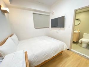 Postel nebo postele na pokoji v ubytování 宏洲旅社HZ Hotel