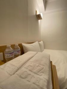Postel nebo postele na pokoji v ubytování 宏洲旅社HZ Hotel