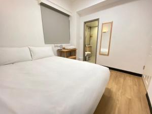 Postel nebo postele na pokoji v ubytování 宏洲旅社HZ Hotel