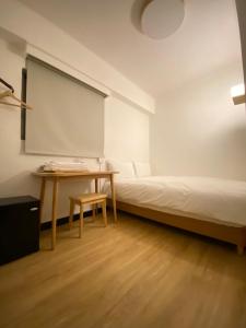 Postel nebo postele na pokoji v ubytování 宏洲旅社HZ Hotel