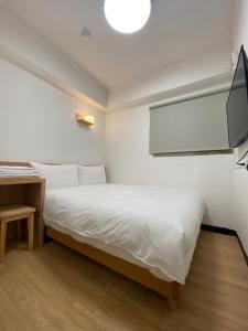 Postel nebo postele na pokoji v ubytování 宏洲旅社HZ Hotel