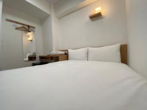 Postel nebo postele na pokoji v ubytování 宏洲旅社HZ Hotel