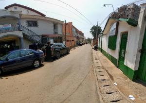 a street with cars parked on the side of the road at The Yafé Bastos 4 in Yaoundé