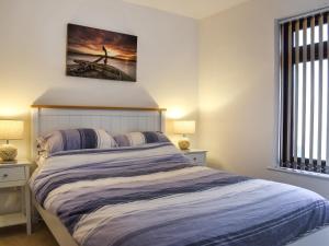a bedroom with a bed with a painting on the wall at Fairways Retreat in Northam