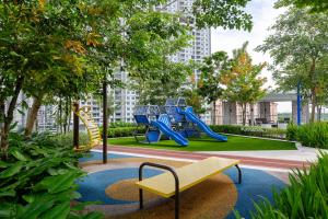 a playground with a slide and a bench at Urban Suites in Jelutong