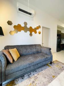 a couch in a living room with a wall at The Opal Suite Troika Kota Bharu 1 Bedroom in Kota Bharu