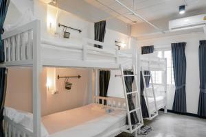 a room with two bunk beds in it at G5 Hostel in Bangkok