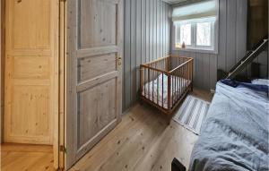 a bedroom with a door and a crib in a room at Awesome Home In Fyresdal With Kitchen in Fyresdal
