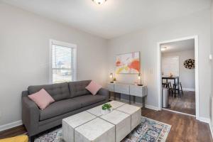a living room with a couch and a table at Downtown home! Walk to Bulls Stadium, DPAC & food in Durham