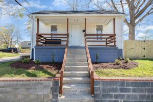 a small house with a staircase leading to the front door at Downtown home! Walk to Bulls Stadium, DPAC & food in Durham