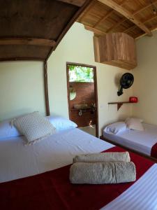Postel nebo postele na pokoji v ubytování Ecorali Lodge