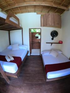 Postel nebo postele na pokoji v ubytování Ecorali Lodge