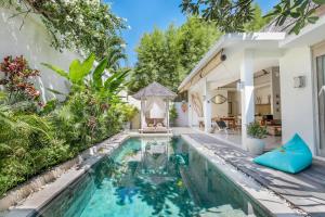 a swimming pool in the backyard of a house at Villa Safari in Seminyak