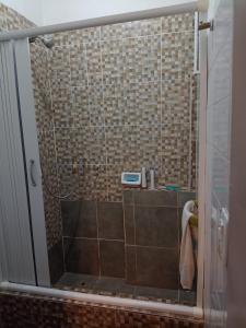 baño con ducha y puerta de cristal en Lo de Nelly en Puerto Madryn